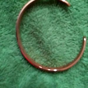 A women's clamp adjustable bracelet.